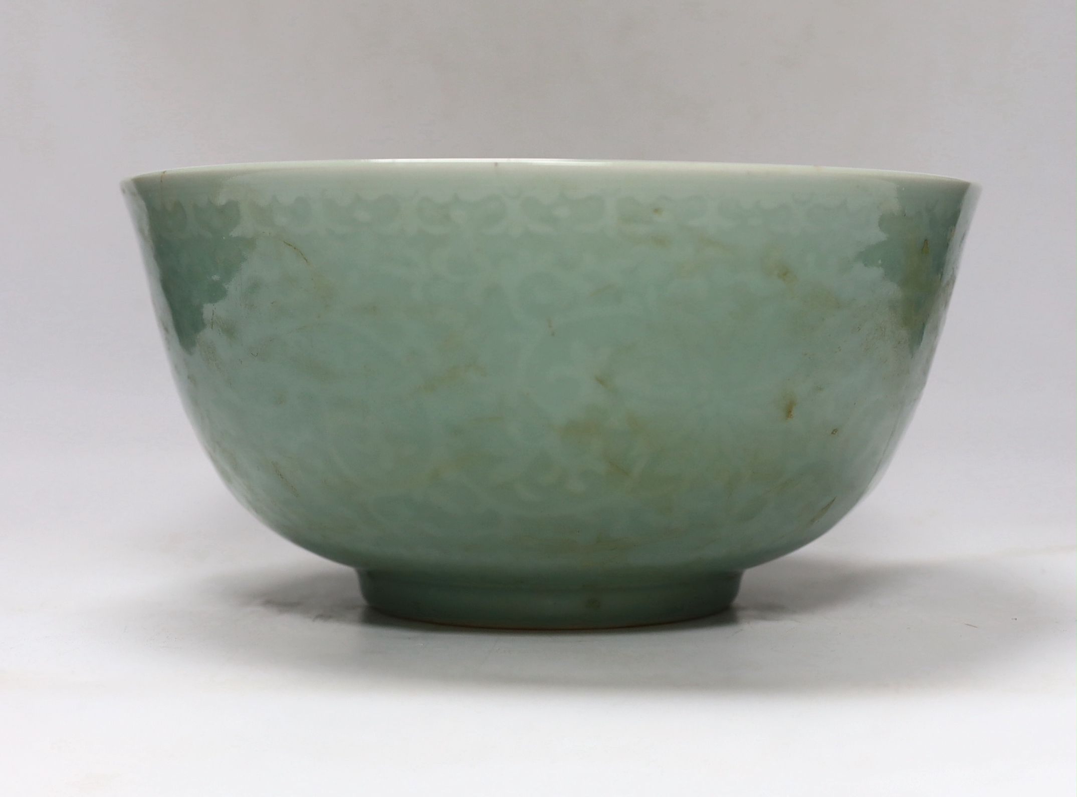 A Chinese celadon glazed ‘lotus’ bowl, 25cm diameter